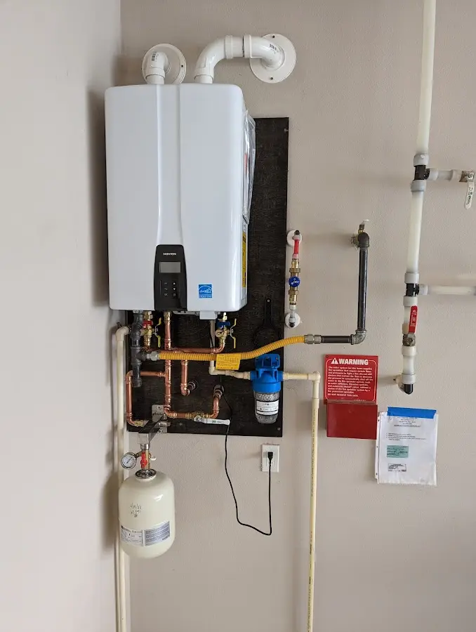 Professional plumber installing copper piping in a Prescott home